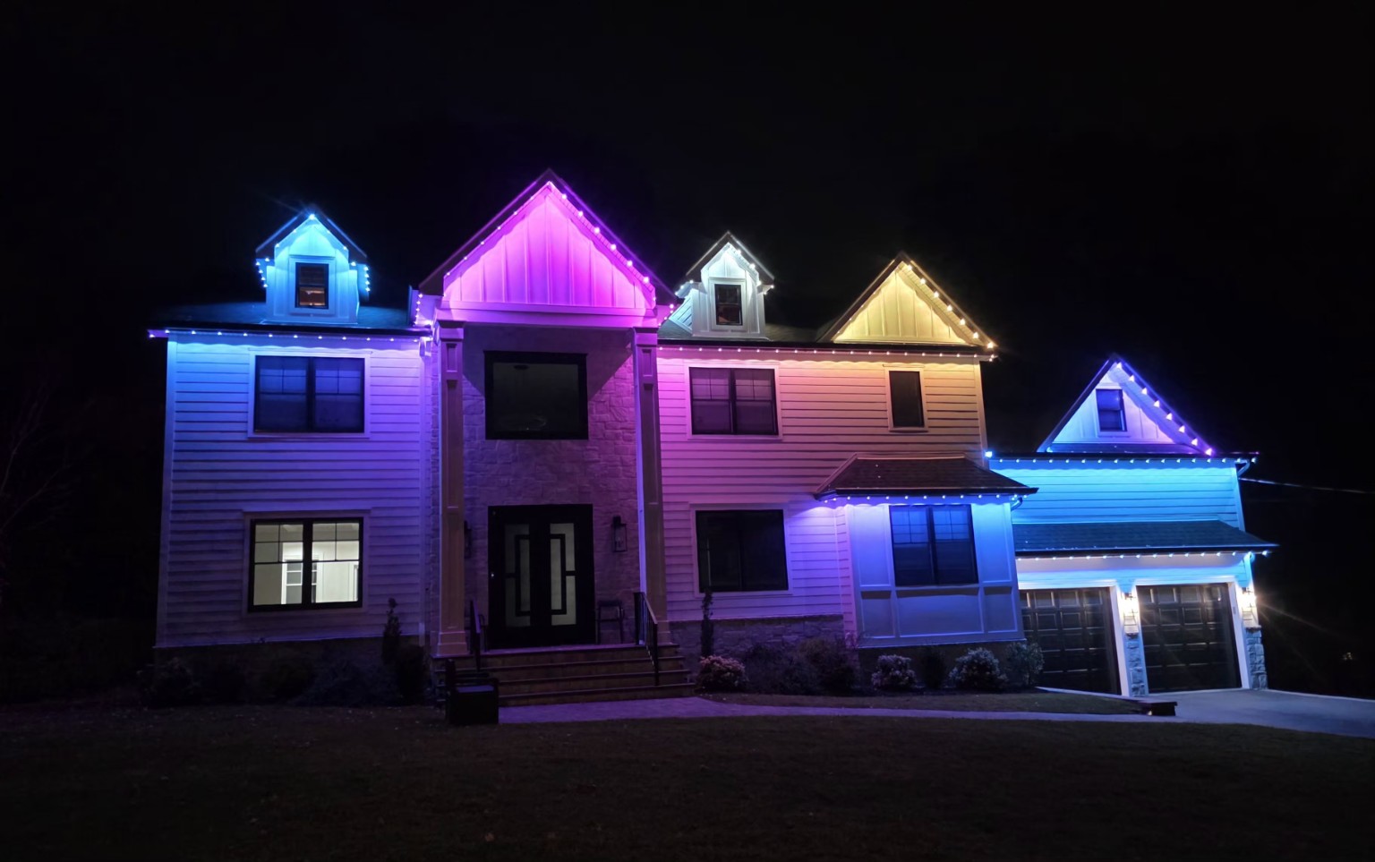 Livingston, New Jersey home with blue, pink, purple and white EverGlow lighting outlining its rooflines and gables
